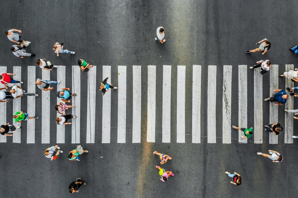 Birds eye view of pedestrians walking at a crosswalk