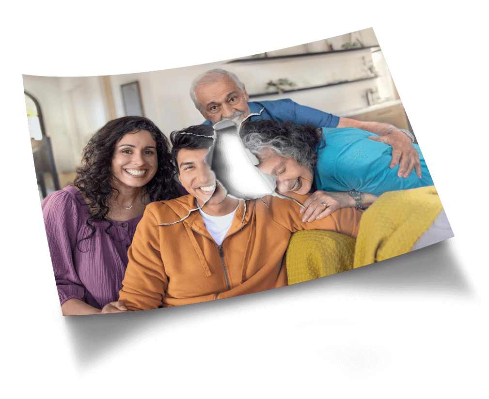 Picture of a smiling family on a sofa with a piece at the center of the photo torn open