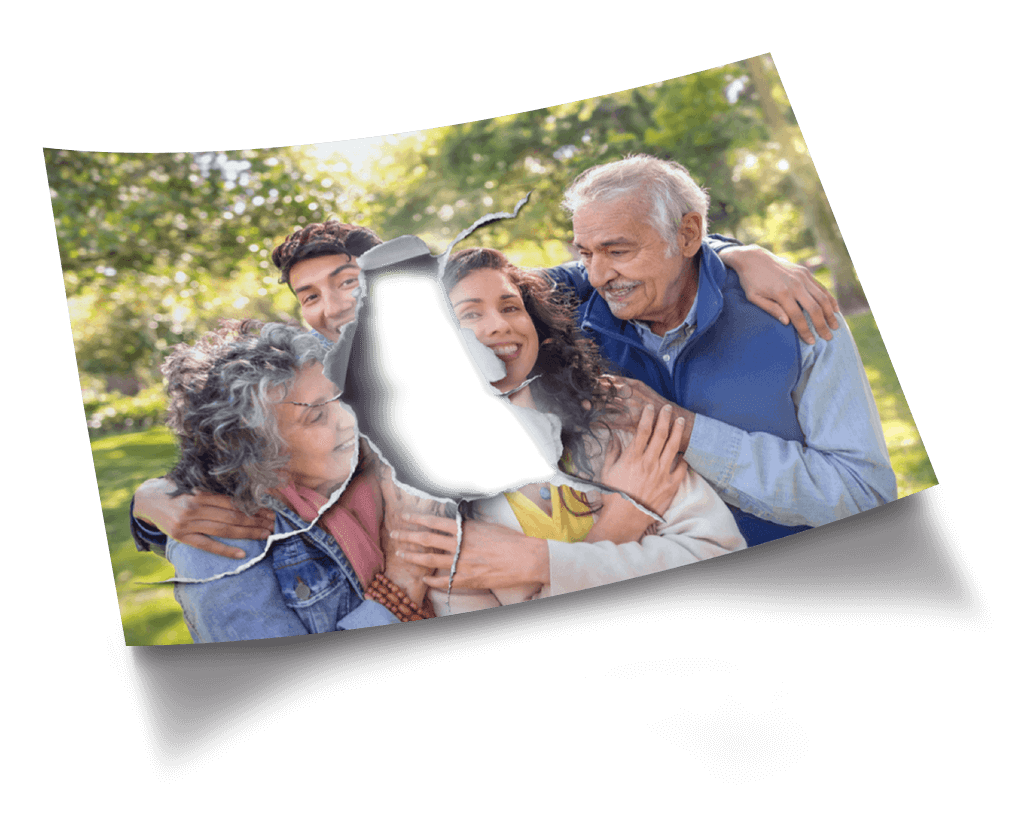 Picture of a smiling family at a park with a piece at the center of the photo torn open